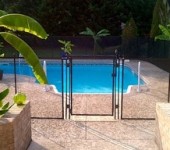 A pool with a gate and a brick wall